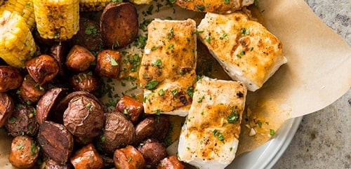 A photo of some fish and potatoes
