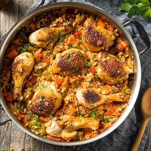 A photo of a chicken dinner in a pan
